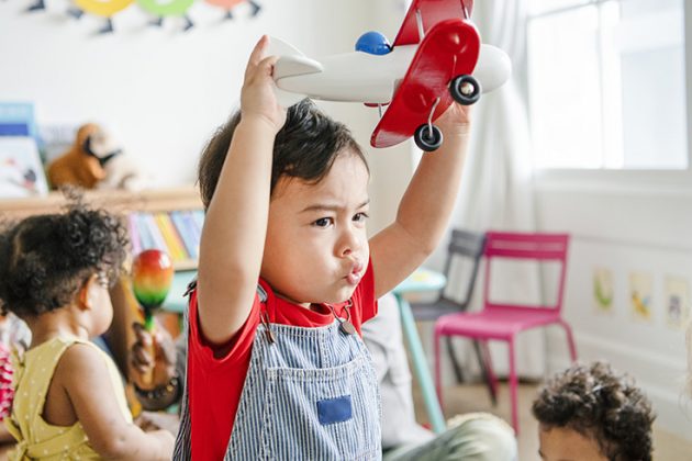 A child in day care plays with a toy | After decades of advocacy, the provincial and federal governments have announced an investment of $3.2 billion over five years in quality, universal and affordable childcare